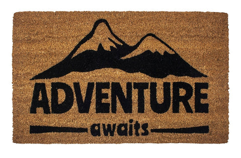 Coir doormat with snowcapped mountain illustration and Adventure Awaits text.